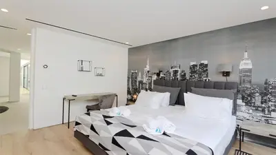 a bedroom with a large white bed with a city backdrop at Villa Malibu - Onesix2, Cleverdetails CD 285 in Vilamoura