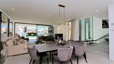 a dining room and living room with a table and chairs at Villa Malibu - Onesix2, Cleverdetails CD 285 in Vilamoura