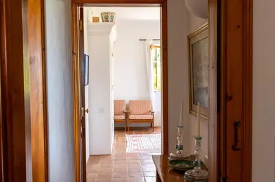 a hallway with a door leading to a living room at Almancil Sea and Countryside Secluded Villa in Quartos