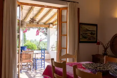a dining room with a table and a sliding glass door at Almancil Sea and Countryside Secluded Villa in Quartos