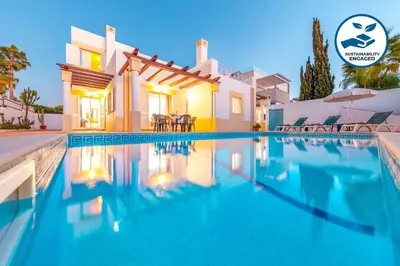 a villa with a swimming pool at dusk at Villa Azzurra by Algarve Vacation in Albufeira