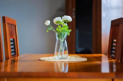 a vase of white flowers sitting on a table at Calm Paradise close to the City in Faro
