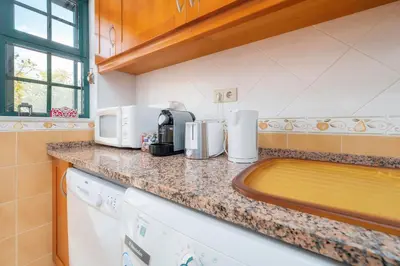 a kitchen with a counter top with appliances on it at Calm Paradise close to the City in Faro