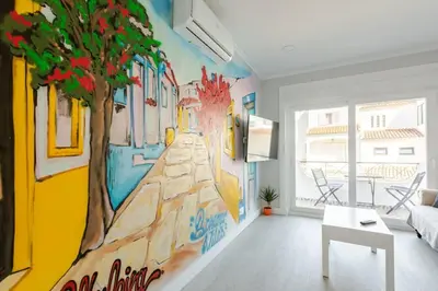 a living room with a mural of a train at BrisaMar Villas: Sol, Mar, Serenidade in Albufeira