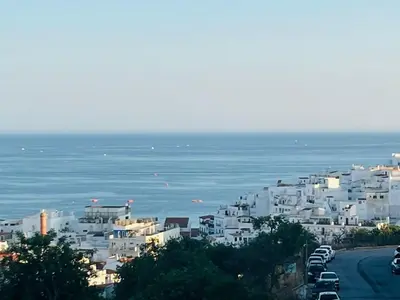 a group of white buildings on a hill next to the ocean at BrisaMar Villas 2 Sol Mar Serenidade in Albufeira