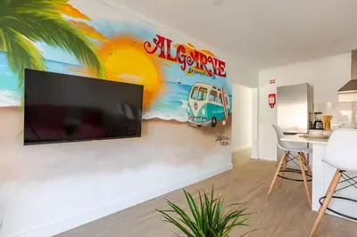 a living room with a large flat screen tv on a wall at BrisaMar Villas 2 Sol Mar Serenidade in Albufeira