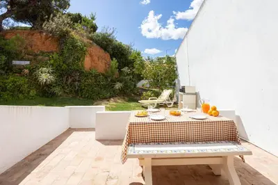 a table with oranges on it on a patio at Villa Mar e Sol by HelloVacations in Olhos de Água