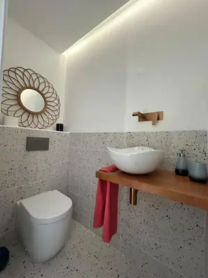 a bathroom with a white toilet and a sink at Casa das Mélias in Vilamoura