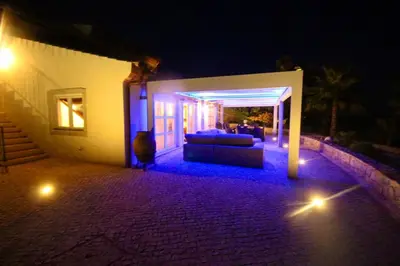 a couch sitting on a patio at night at Casa Grayson in Loulé