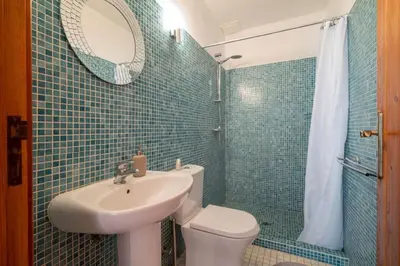 a bathroom with a sink and a toilet and a mirror at Casa Grayson in Loulé
