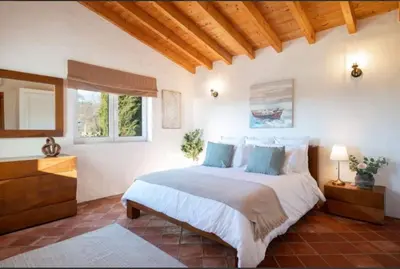 a bedroom with a large bed and a window at Casa Grayson in Loulé