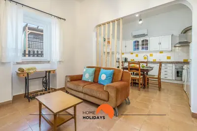 a living room with a couch and a kitchen at #236 Texugueiras 148 by Home Holidays in Ferreiras