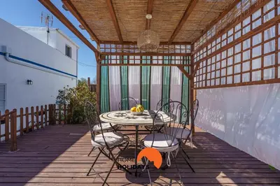 a patio with a table and chairs on a deck at #236 Texugueiras 148 by Home Holidays in Ferreiras