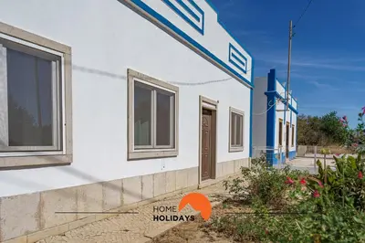 a house with windows on the side of it at #236 Texugueiras 148 by Home Holidays in Ferreiras
