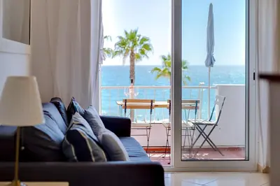 a living room with a couch and a view of the ocean at Maresia 2 Bedroom Oceanfront Apartment in Quarteira in Quarteira