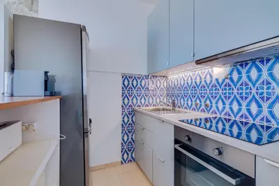 a kitchen with blue and white tiles on the wall at Maresia 2 Bedroom Oceanfront Apartment in Quarteira in Quarteira