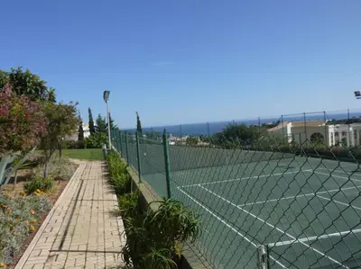 a tennis court with a net on top of it at Encosta Do Sol in Albufeira