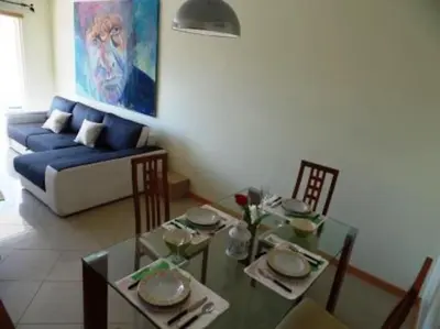 a living room with a table and a blue couch at Encosta Do Sol in Albufeira