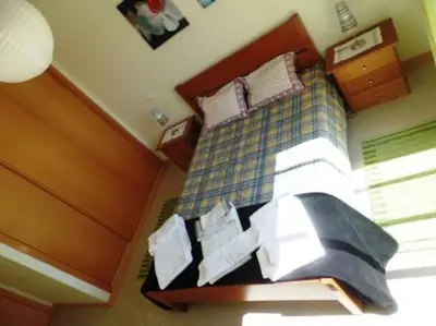 a bedroom with a bed with a blue and white at Encosta Do Sol in Albufeira