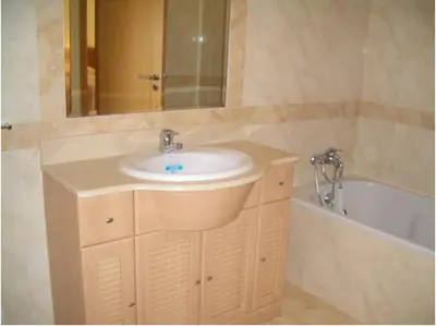 a bathroom with a sink and a bath tub at Akisol Albufeira Aqua II in Albufeira