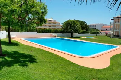 a swimming pool in the yard of a house at Akisol Albufeira Aqua II in Albufeira