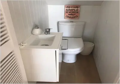 a small bathroom with a toilet and a sink at Windmill Hill - Alto do Moinho - Pool & Sea View in Albufeira