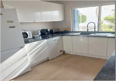 a white kitchen with a sink and a refrigerator at Windmill Hill - Alto do Moinho - Pool & Sea View in Albufeira