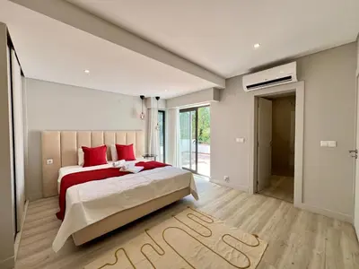 a bedroom with a large bed with red pillows at Vilamoura Premium Villa With Pool by Homing in Vilamoura