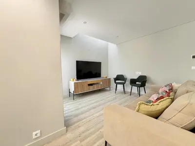 a living room with a couch and a flat screen tv at Vilamoura Premium Villa With Pool by Homing in Vilamoura