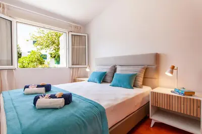 a bedroom with two beds with stuffed animals on them at Villa Palancar by Algarve Vacation in Albufeira