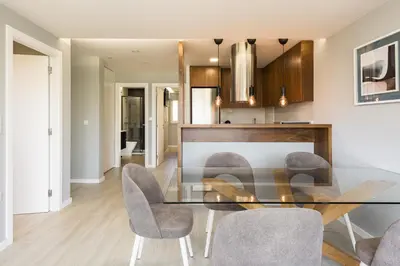 a dining room with a glass table and chairs at SeaVillage Asia - City Center by HD in Vilamoura