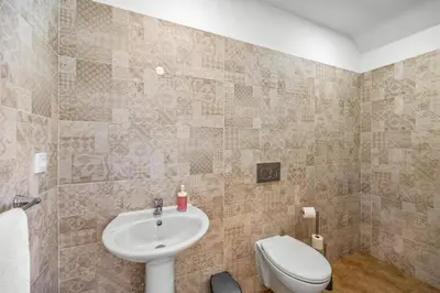 a bathroom with a sink and a toilet at Villa Casa Joao by Villa Plus in Albufeira