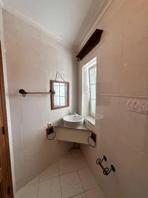 a bathroom with a sink and a window at Villa com piscinas - Quintinha do Lago in Quarteira