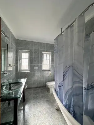 a bathroom with a tub and a sink and a toilet at Villa com piscinas - Quintinha do Lago in Quarteira