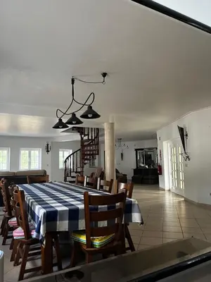 a dining room with a blue and white table and chairs at Villa com piscinas - Quintinha do Lago in Quarteira