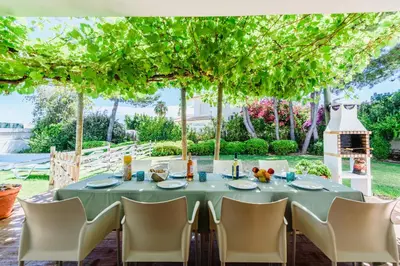 a dining room with a table and chairs and a large window at Villa 715 - our Albufeira holiday retreat in Albufeira