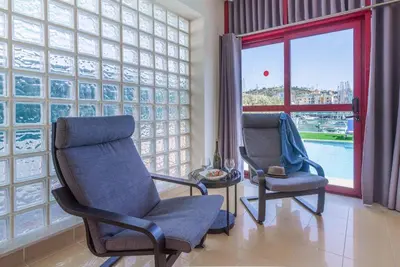 two chairs in a room with a large window at Villa Malibu Marina in Albufeira