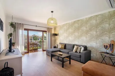 a living room with a couch and a table at Cosy Apartment With Pool 2 in Vilamoura