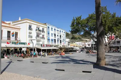 a white building on the side of a street at Paulos Studio in Faro