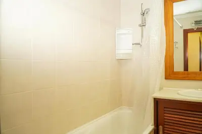 a bathroom with a bath tub and a sink at Salgados Apartment in Albufeira