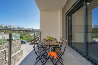 a table and chairs on the balcony of a house at #235 New City by Home Holidays in Albufeira