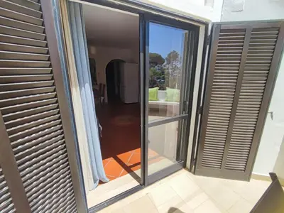 a balcony with sliding glass doors in a house at Albufeira, T1 in Balaia Golf Village, Algarve in Albufeira