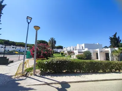 a white building with a staircase next to a tree at Albufeira, T1 in Balaia Golf Village, Algarve in Albufeira