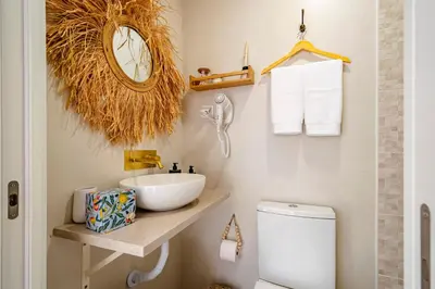 a bathroom with a sink and a toilet at Casas das Ilhas in Faro