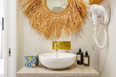 a bathroom with a bowl sink on a counter at Casas das Ilhas in Faro