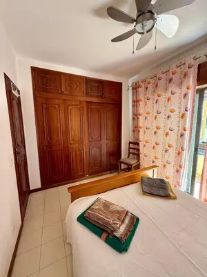 a living room with a table and chairs and a couch at Espadarte Quarteira Balcony Flat in Quarteira