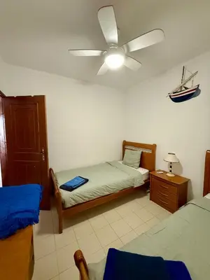 a bedroom with two beds and a ceiling fan at Espadarte Quarteira Balcony Flat in Quarteira