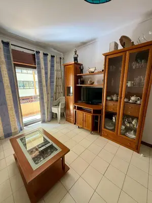 a kitchen with a table and a sink in it at Espadarte Quarteira Balcony Flat in Quarteira