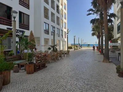 an empty street with tables and chairs and a building at Espadarte Quarteira Balcony Flat in Quarteira