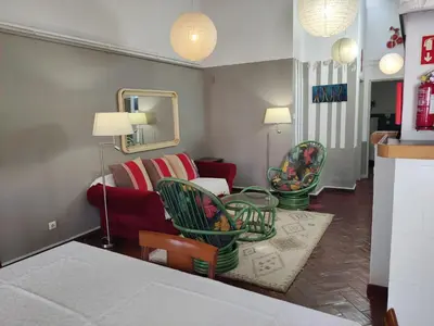 a living room with a couch and chairs at Quinta dos Amigos in Almancil